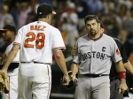 Red Sox Varitek looks towards Orioles pitcher Baez after being tagged him out in Baltimore