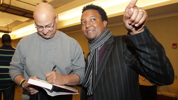 Tito autographs a book for his former ace