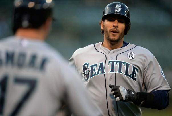 Michael Morse #38 of the Seattle Mariners is congratulated by Justin Smoak #17 after Morse hit a solo home run against the Oakland Athletics in the first inning at O.co Coliseum on April 3, 2013 in Oakland, California. Morse hit 4 HRs in the 4 games series split between the Athletics and Mariners. Morse carries a 3 Slash Line of .295/348/.847