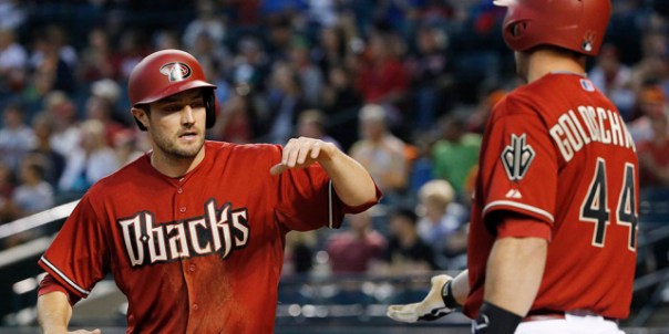 Arizona Diamondbacks' A.J. Pollock, left, slaps hands with Paul Goldschmidt (44) after Pollock scored a run against the San Francisco Giants during the first inning of a baseball game Wednesday, April 8, 2015, in Phoenix. (AP Photo/Ross D. Franklin)